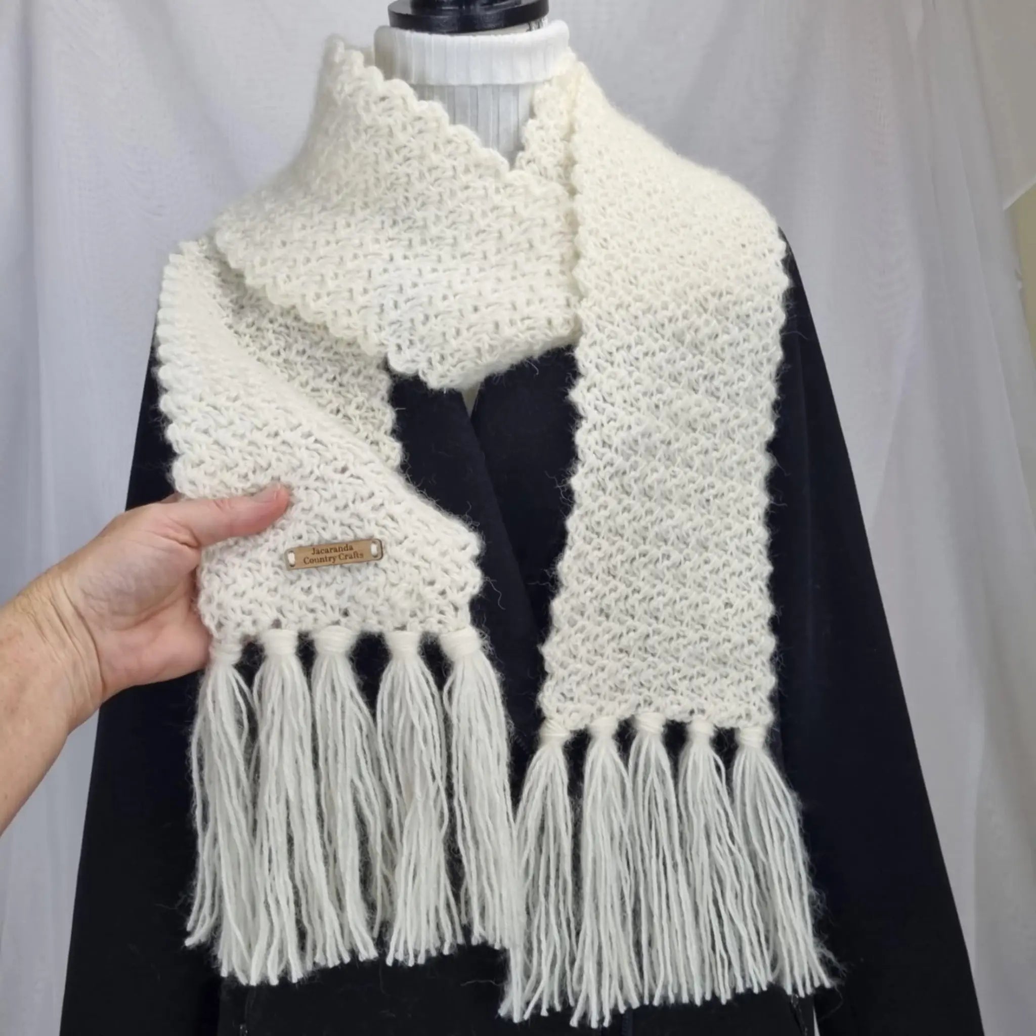 White knitted scarf with tassels on a mannequin against a white background Heirloom Cosy Scarf