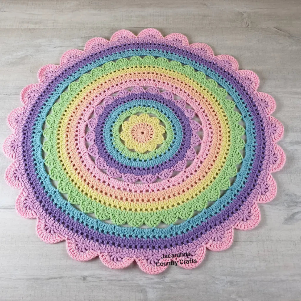 Colorful crocheted rug with concentric circles on a wooden floor