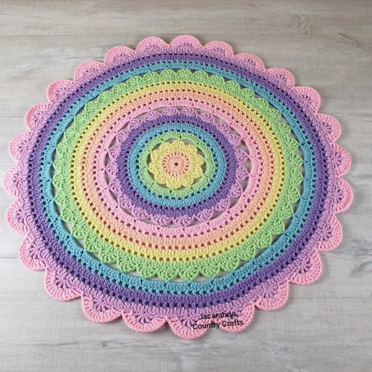Colorful crocheted rug with concentric circles on a wooden floor